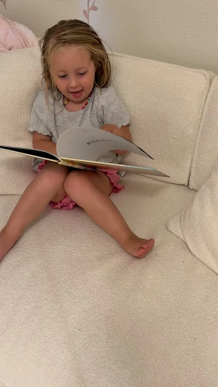 A child looking through her personalized Sundayfawn storybook